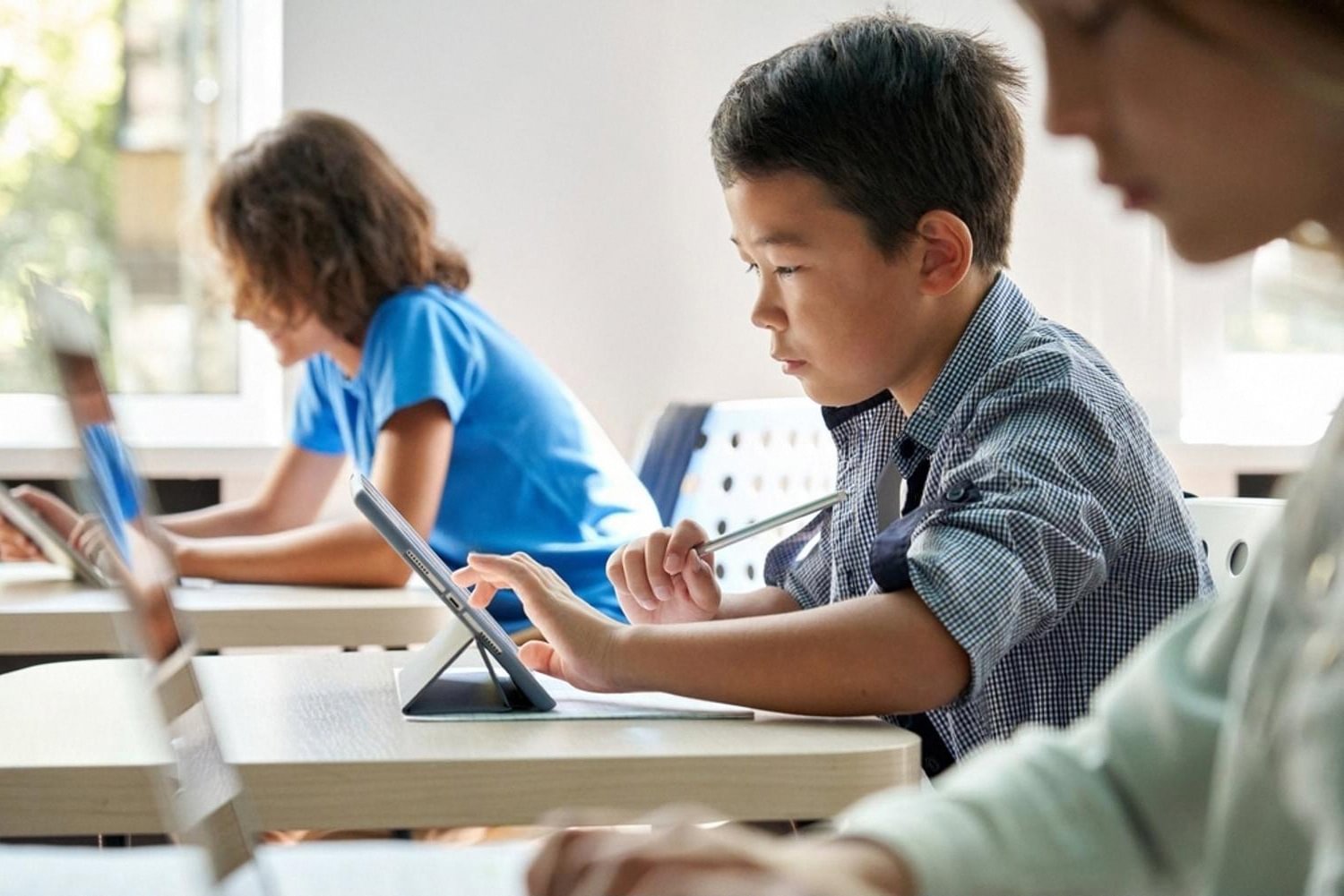 Students using tablets during a lesson at an international school in Ajman